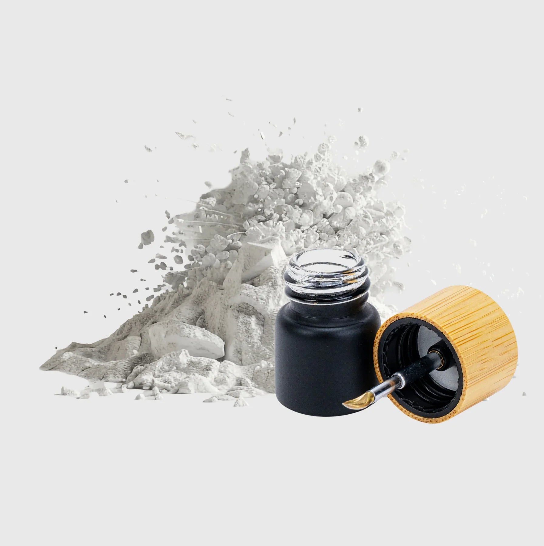 Natürliches Cannabisöl in schwarzem Glasfläschchen mit Bambusdeckel und Pinsel, umgeben von pulverisiertem Material