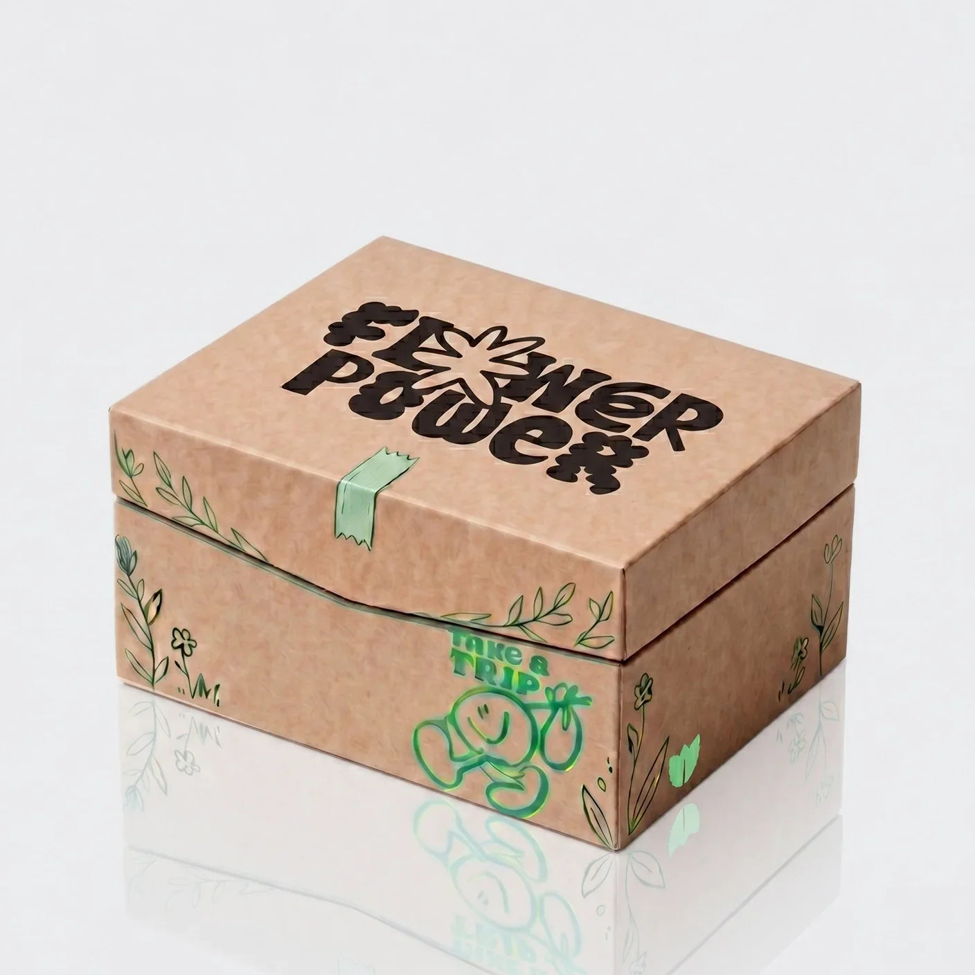 Flower Power Verpackung mit grünen Blumenmotiven und 'Take a Trip' Aufschrift
